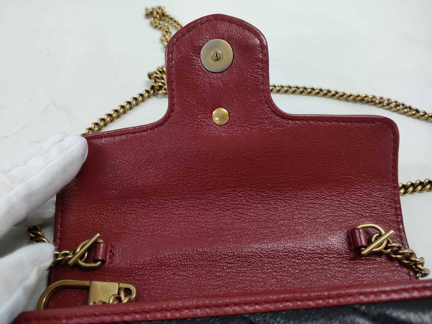 GUCCI Super Mini GG Marmont Matelasse Leather Shoulder Bag in Black, Red, and Gold Hardware with Chain Shoulder Strap