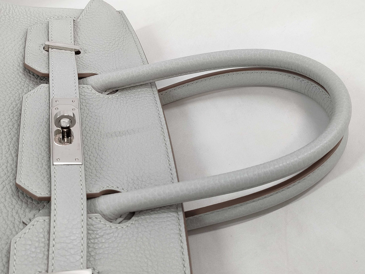 HERMES Birkin 30 handbag in ivory with silver hardware and a C stamp.
