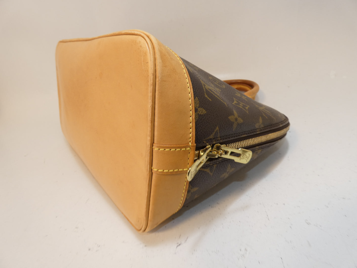 LOUIS VUITTON Alma Monogram Handbag