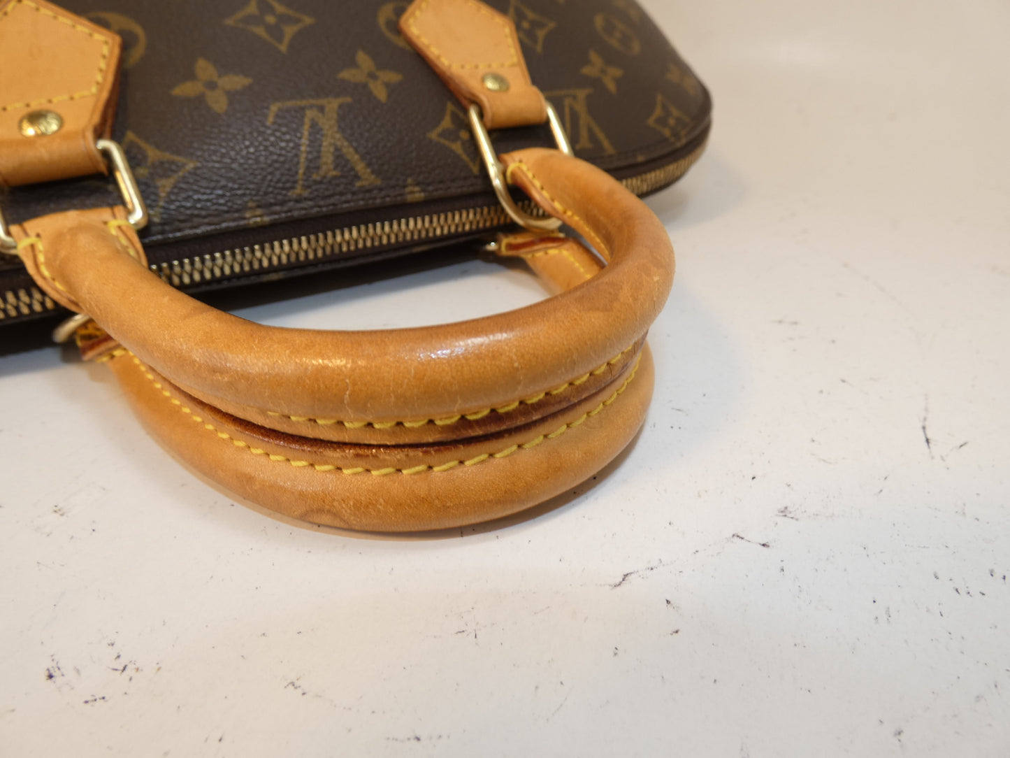 LOUIS VUITTON Alma Monogram Handbag