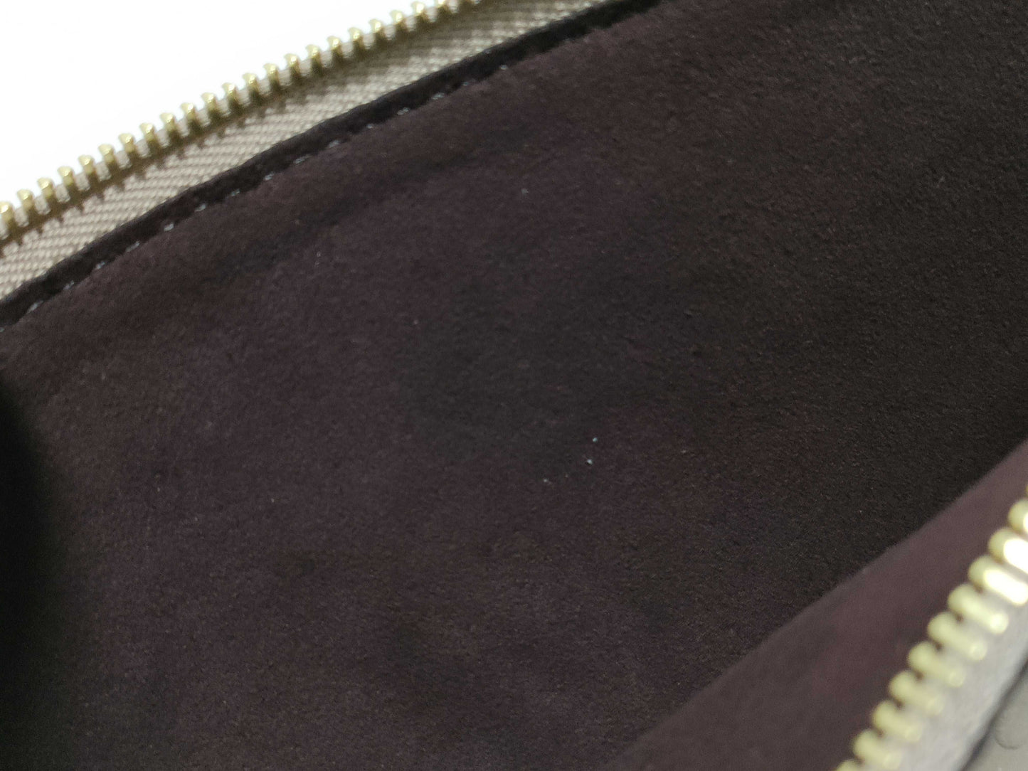 LOUIS VUITTON RFID verification impossible. Serial number verification impossible. Monogram Empreinte Louis Vuitton Neverfull Pouch in Taupe with Gold Hardware.