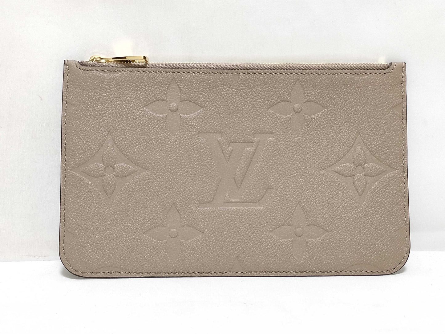 LOUIS VUITTON RFID verification impossible. Serial number verification impossible. Monogram Empreinte Louis Vuitton Neverfull Pouch in Taupe with Gold Hardware.
