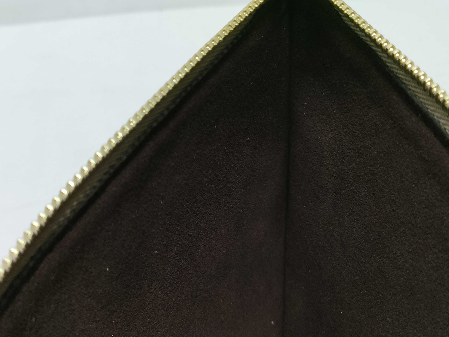 LOUIS VUITTON RFID verification impossible. Serial number verification impossible. Monogram Empreinte Louis Vuitton Neverfull Pouch in Taupe with Gold Hardware.