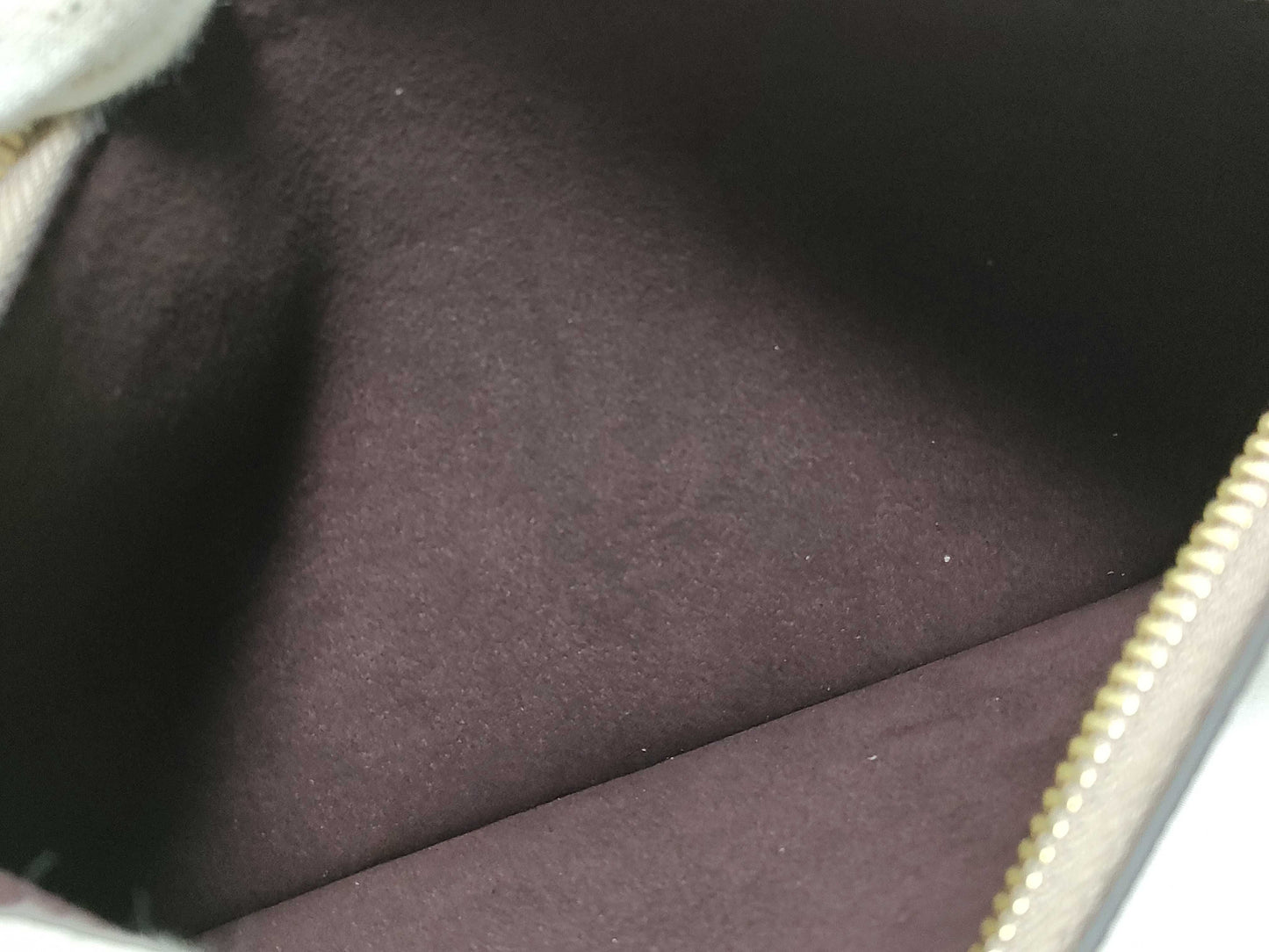 LOUIS VUITTON RFID verification impossible. Serial number verification impossible. Monogram Empreinte Louis Vuitton Neverfull Pouch in Taupe with Gold Hardware.