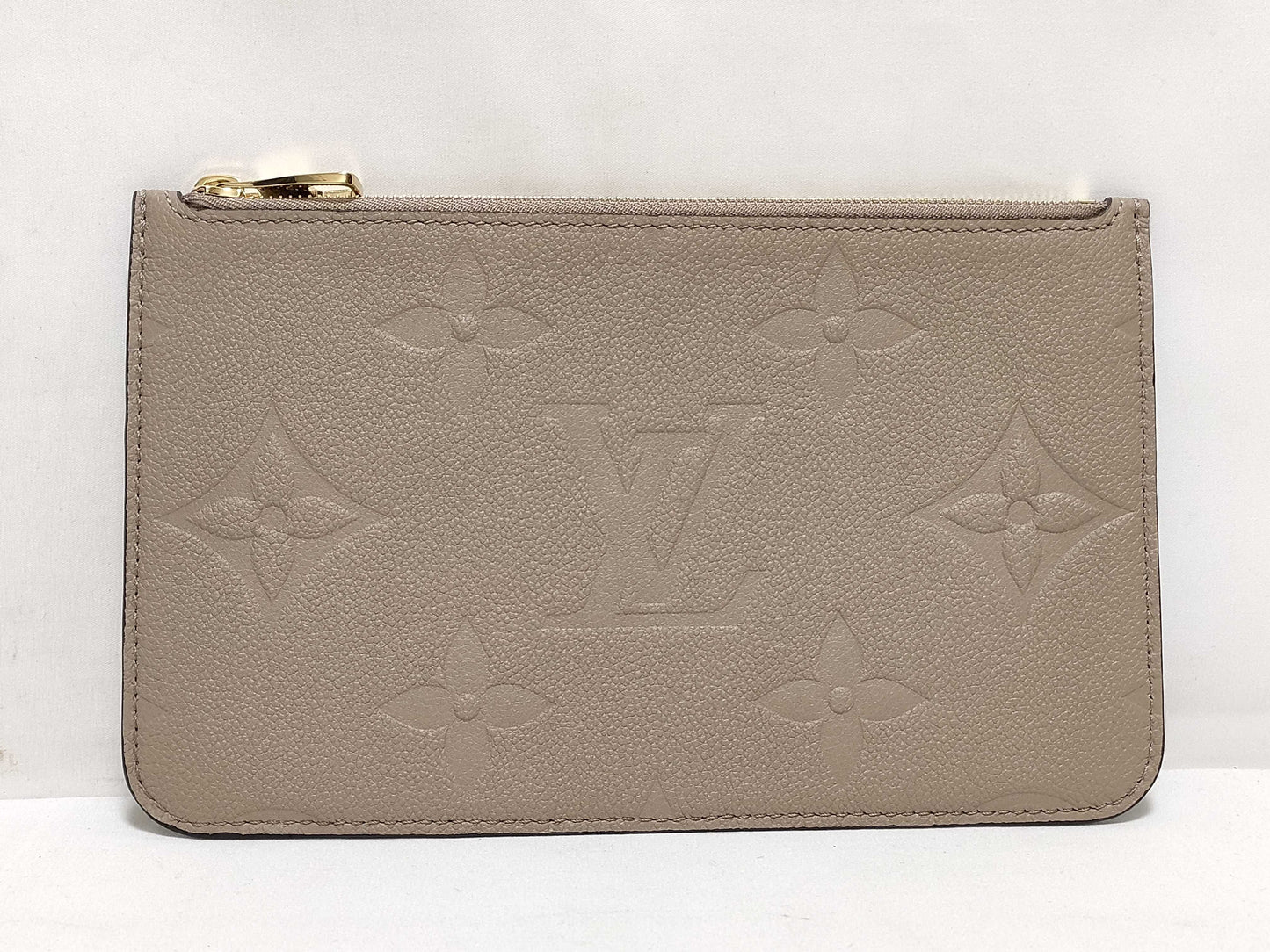 LOUIS VUITTON RFID verification impossible. Serial number verification impossible. Monogram Empreinte Louis Vuitton Neverfull Pouch in Taupe with Gold Hardware.