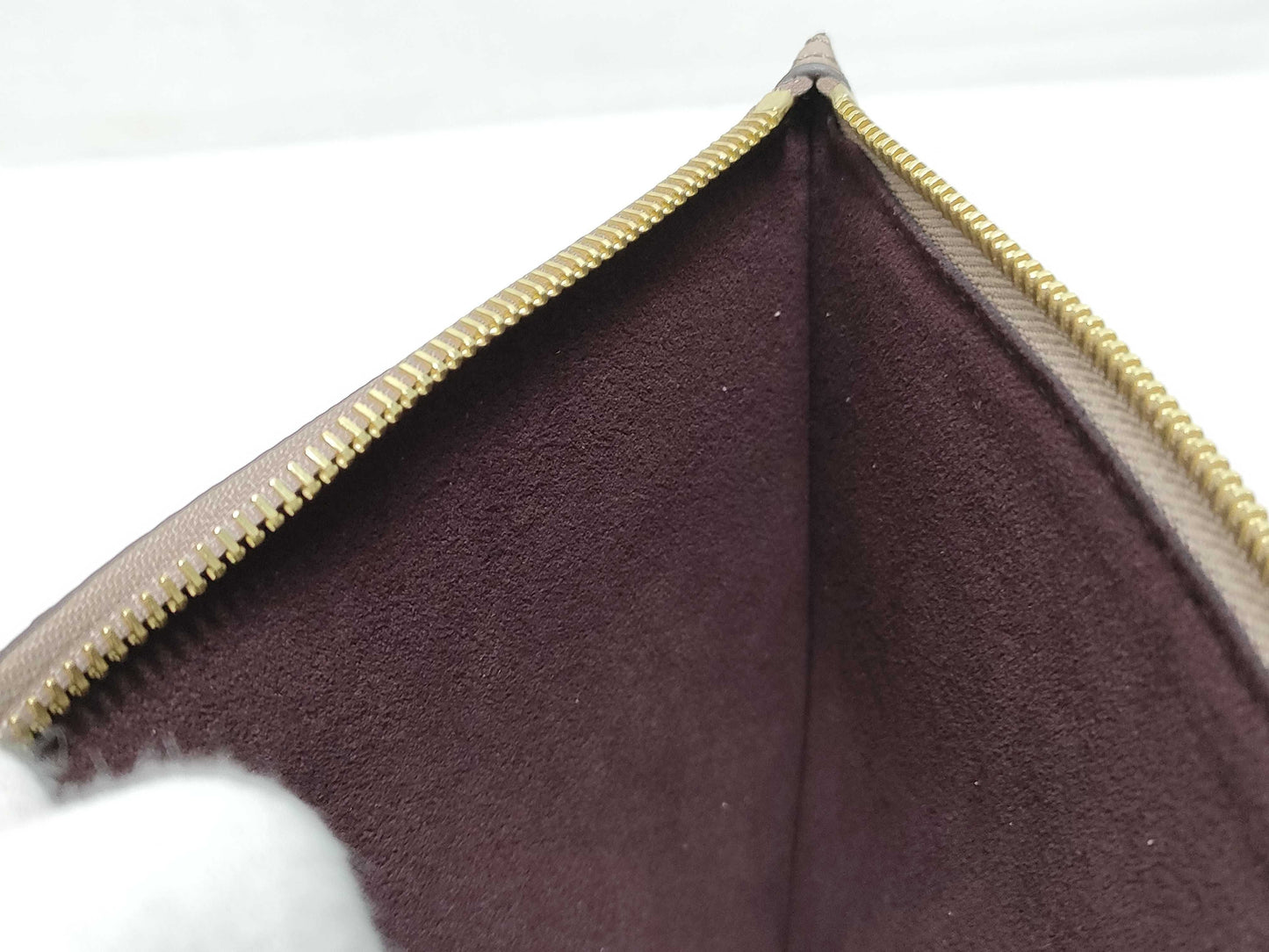 LOUIS VUITTON RFID verification impossible. Serial number verification impossible. Monogram Empreinte Louis Vuitton Neverfull Pouch in Taupe with Gold Hardware.