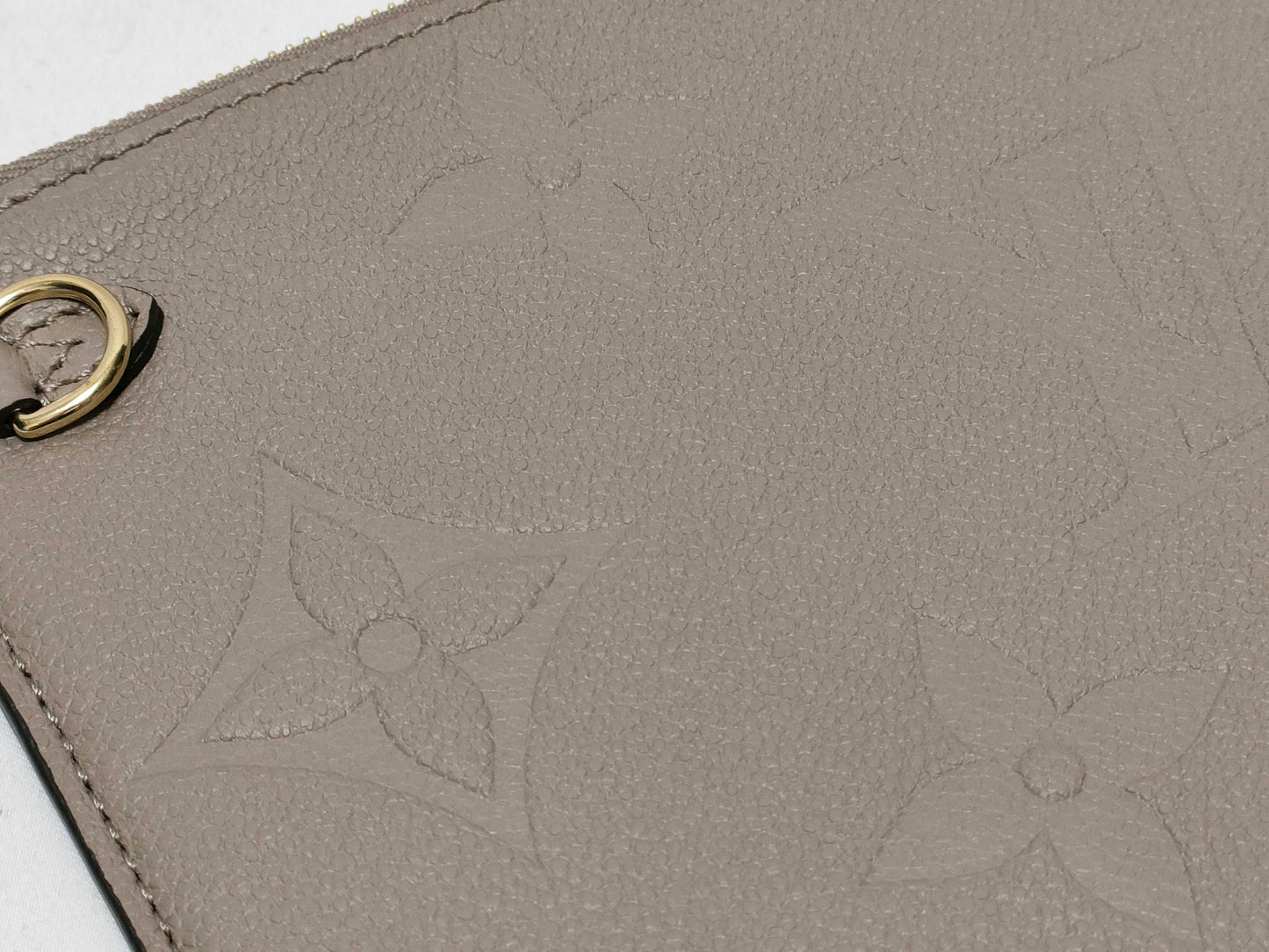 LOUIS VUITTON RFID verification impossible. Serial number verification impossible. Monogram Empreinte Louis Vuitton Neverfull Pouch in Taupe with Gold Hardware.