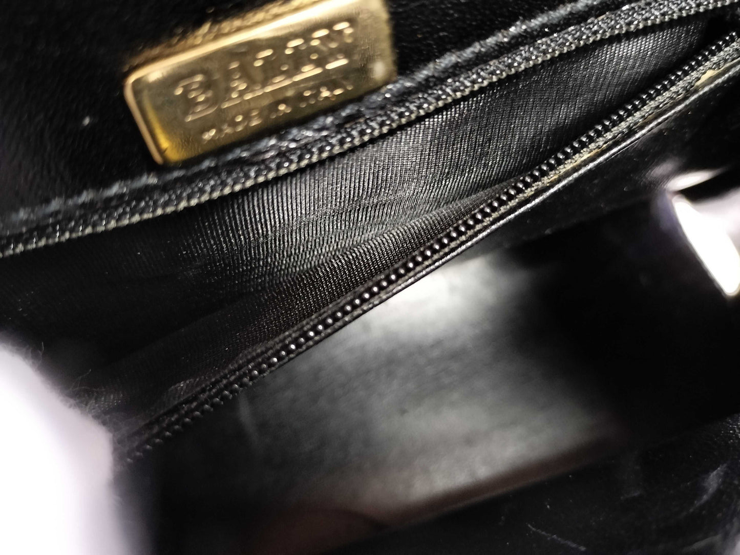 BALLY 2-way Kelly-style shoulder bag with top handle and turnlock. Black leather.