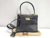 BALLY 2-way Kelly-style shoulder bag with top handle and turnlock. Black leather.