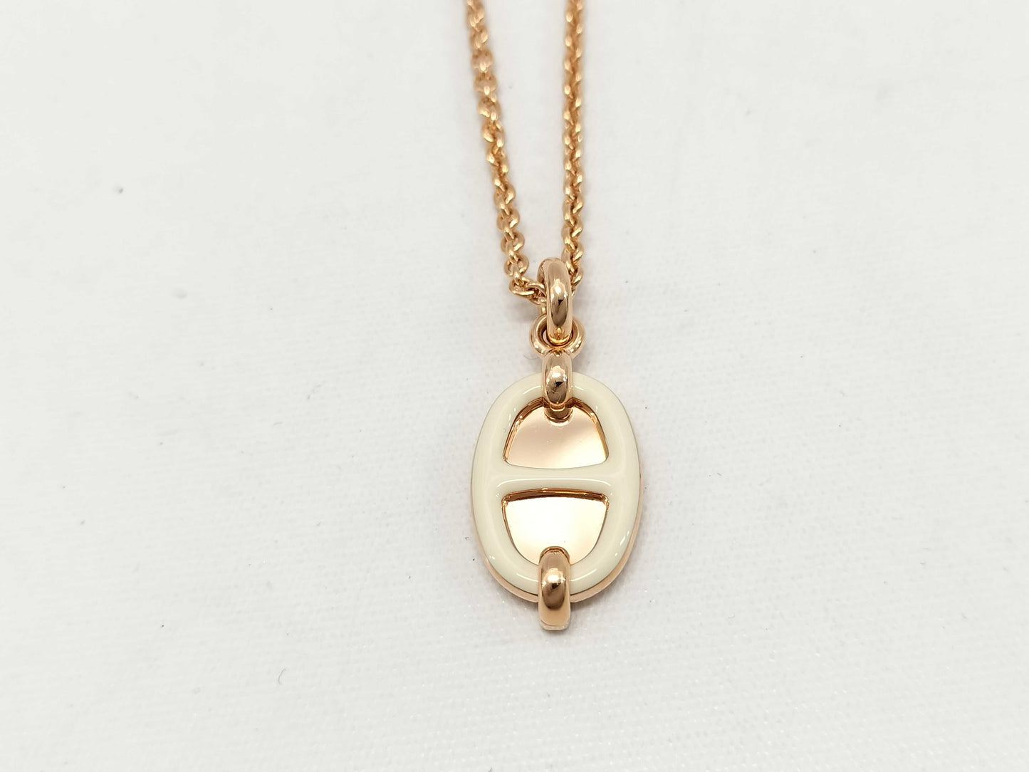 HERMES Mini Maillon pendant in cream with pink gold hardware. Necklace