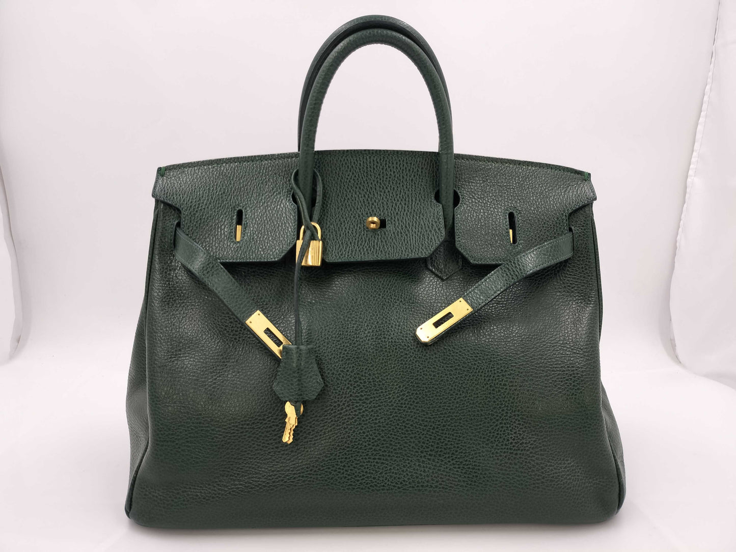 Green handbag with padlock, key and clochette