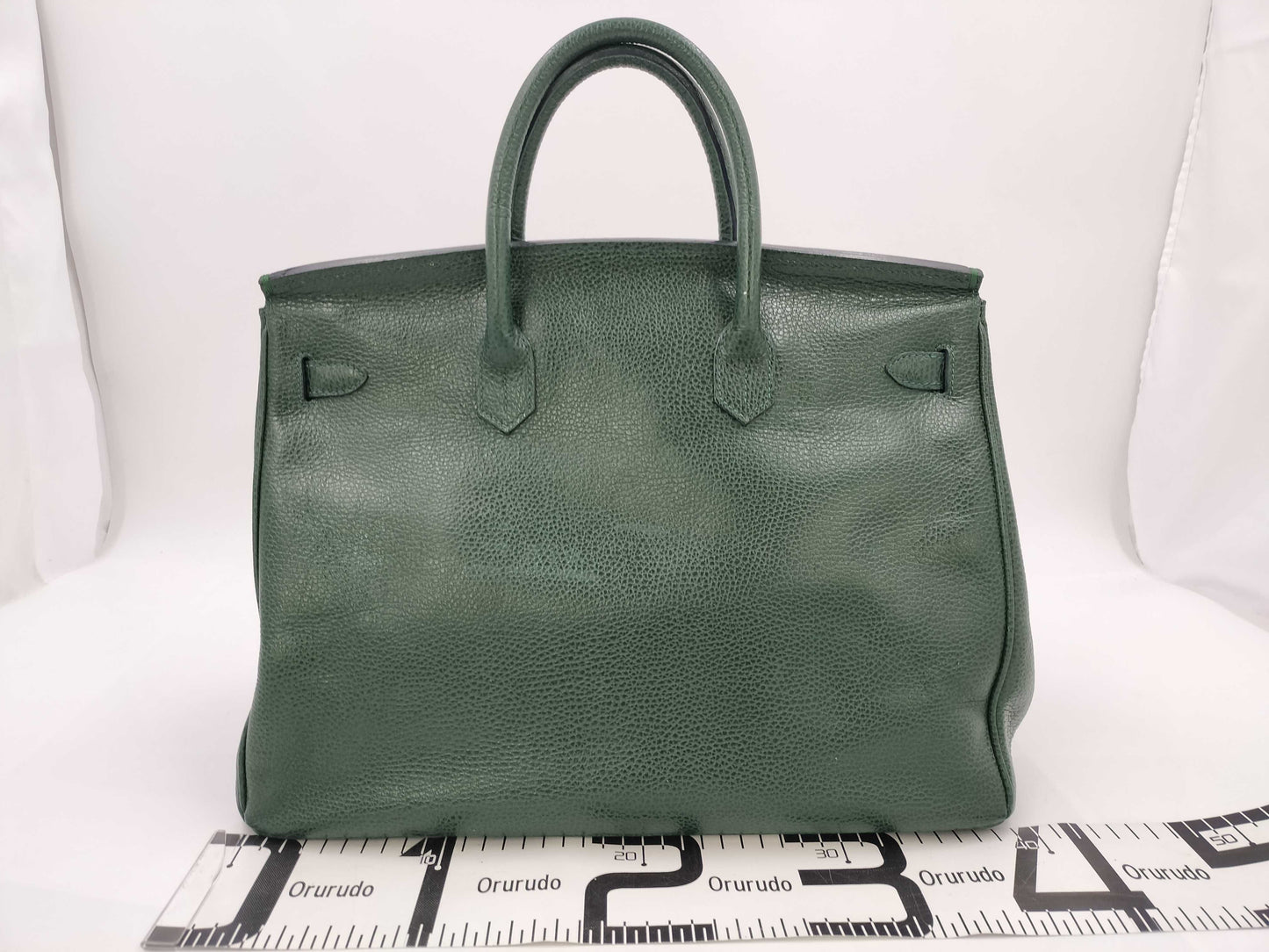Green handbag with padlock, key and clochette