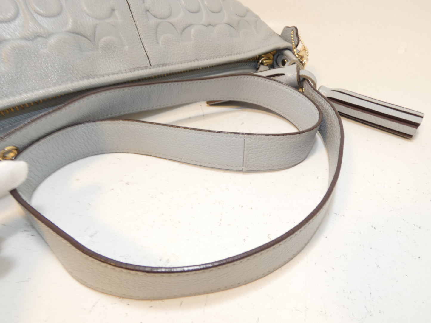 COACH Signature Embossed Leather Tassel Shoulder Bag