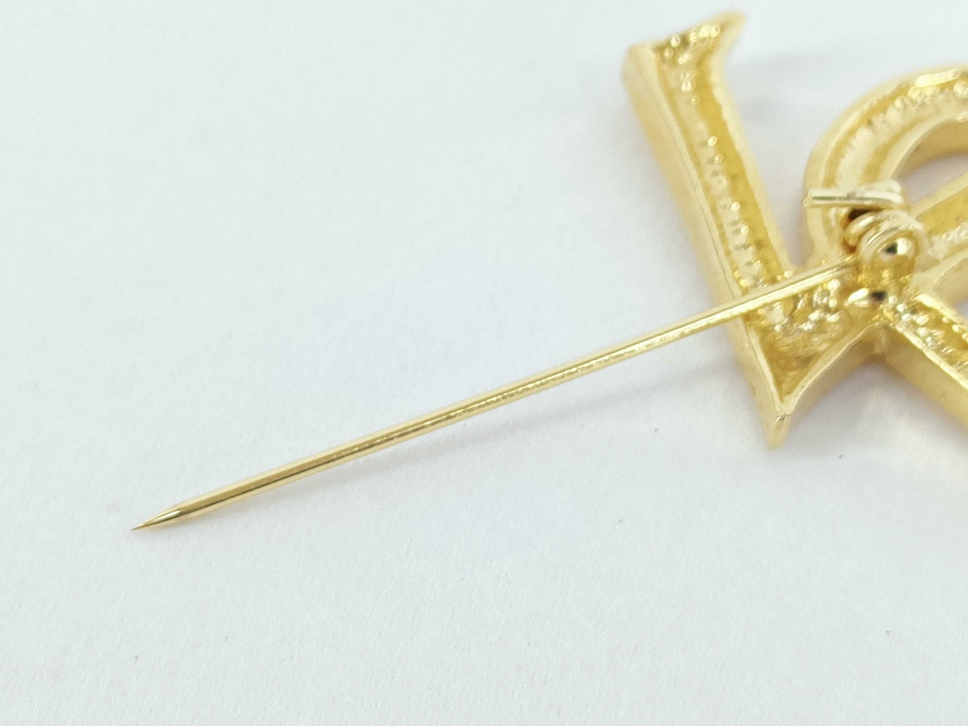 Yves Saint Laurent logo brooch