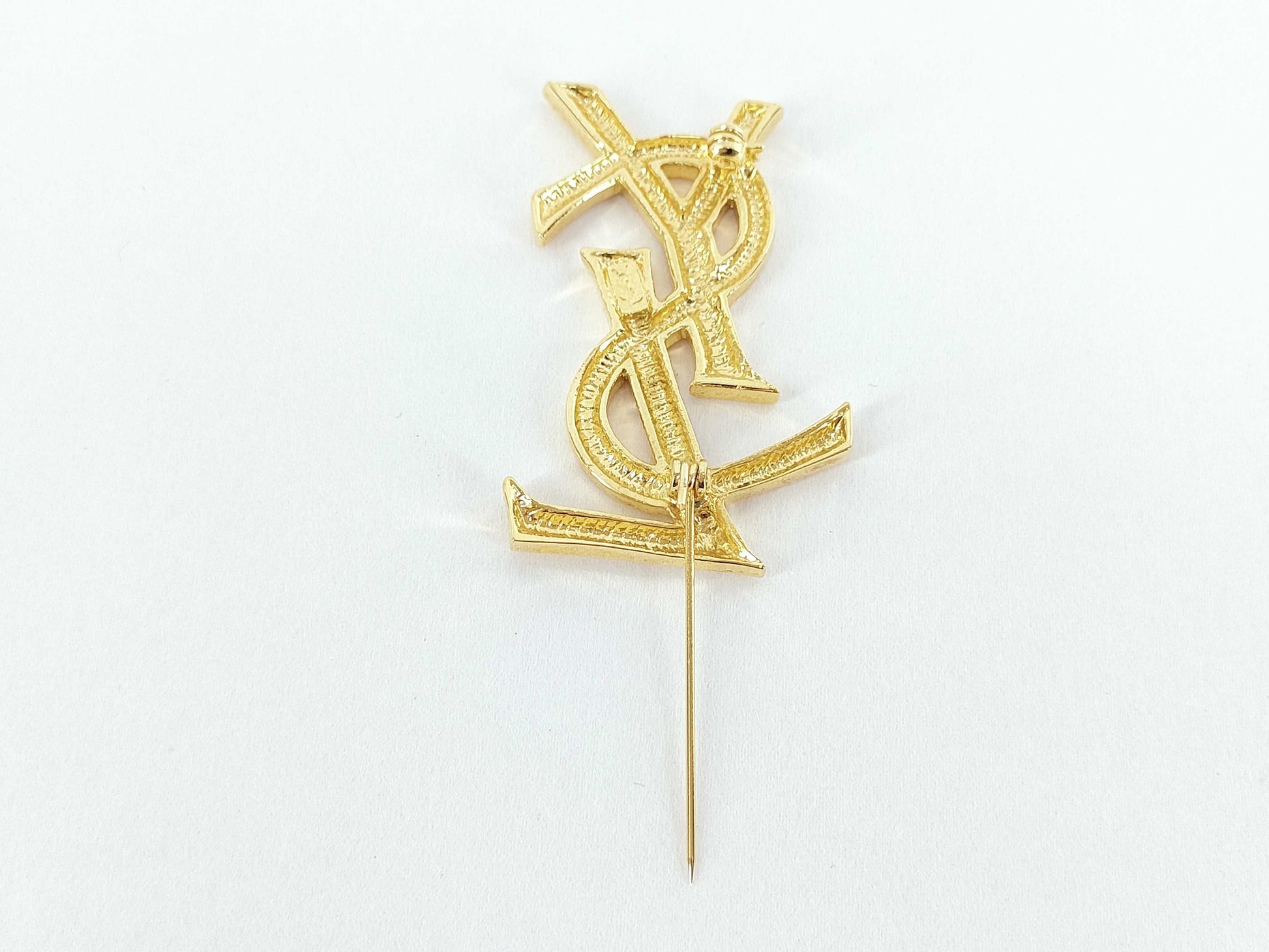 Yves Saint Laurent logo brooch