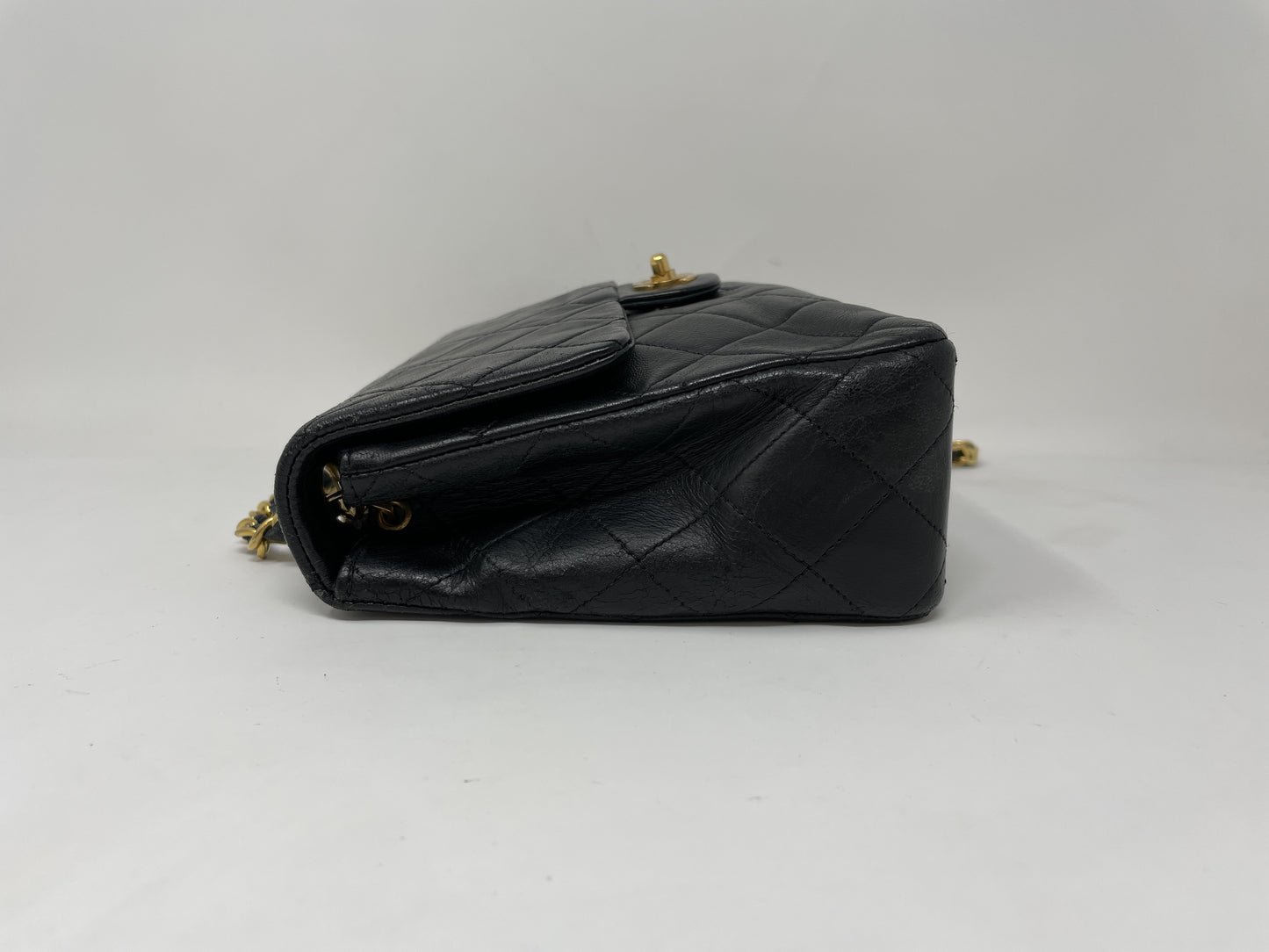 CHANEL CHANEL Mini Matelasse Shoulder Bag with Gold Hardware, Lambskin Coco Mark, and Turn Lock.
