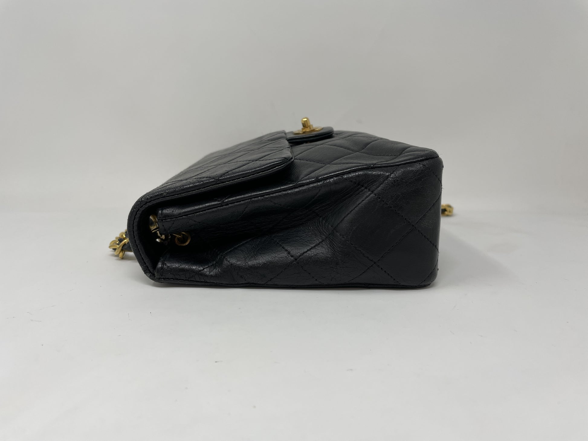 CHANEL CHANEL Mini Matelasse Shoulder Bag with Gold Hardware, Lambskin Coco Mark, and Turn Lock.