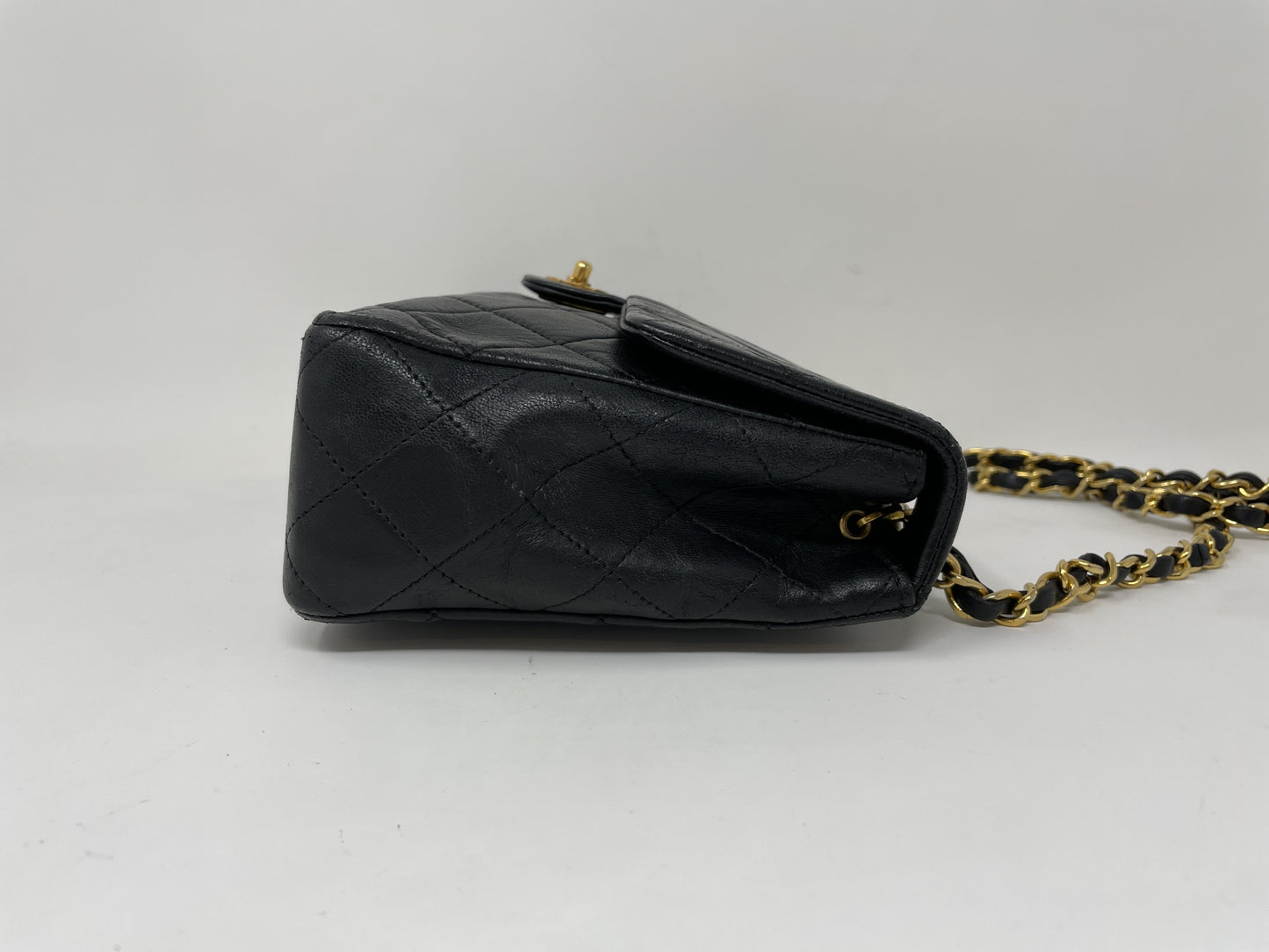 CHANEL CHANEL Mini Matelasse Shoulder Bag with Gold Hardware, Lambskin Coco Mark, and Turn Lock.