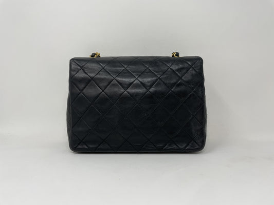 CHANEL CHANEL Mini Matelasse Shoulder Bag with Gold Hardware, Lambskin Coco Mark, and Turn Lock.