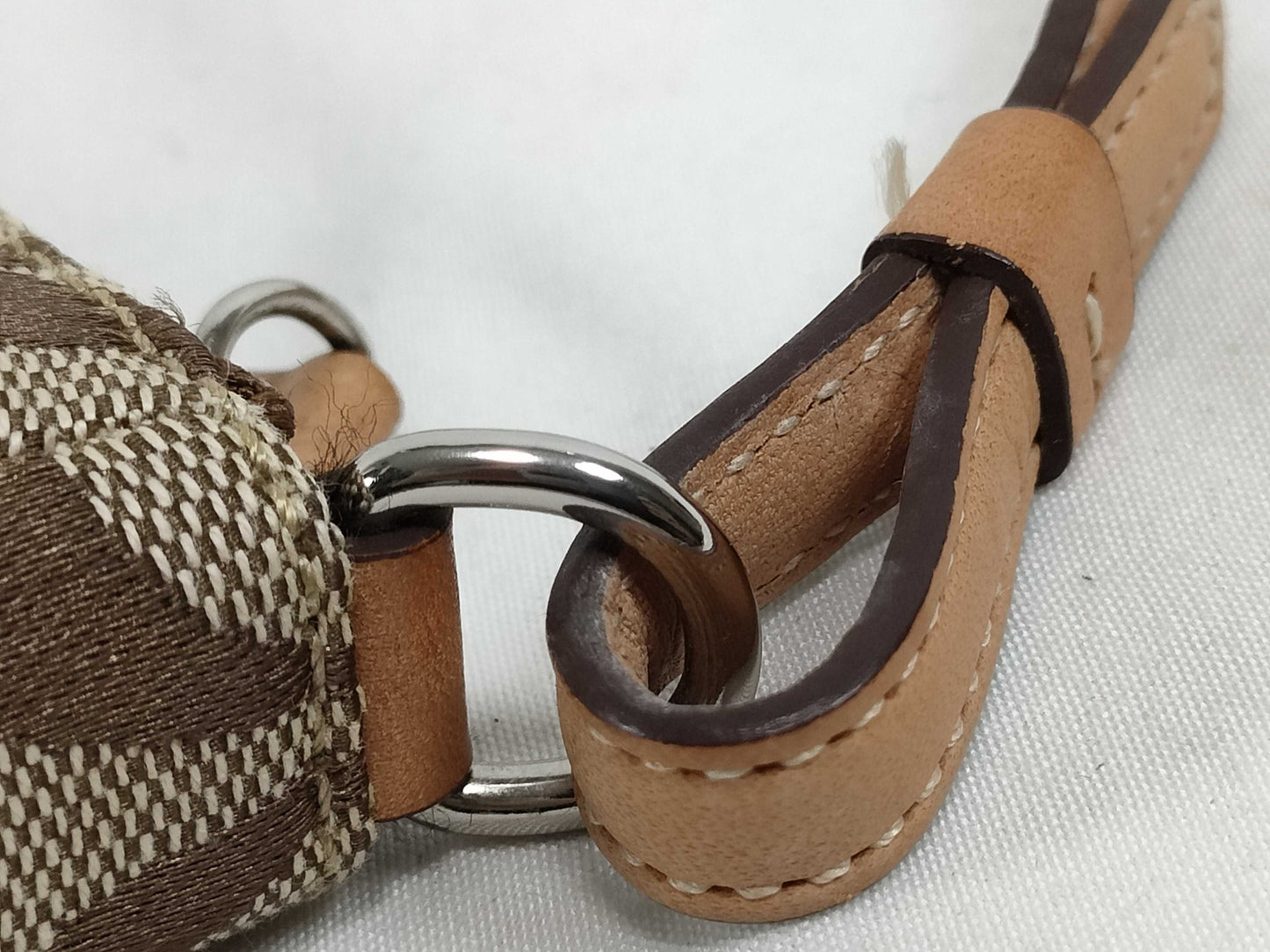 COACH Signature Stripe Patent Leather Accessory Pouch in Light Brown Canvas with Logo Charm.