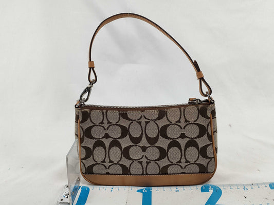 COACH Signature Stripe Patent Leather Accessory Pouch in Light Brown Canvas with Logo Charm.