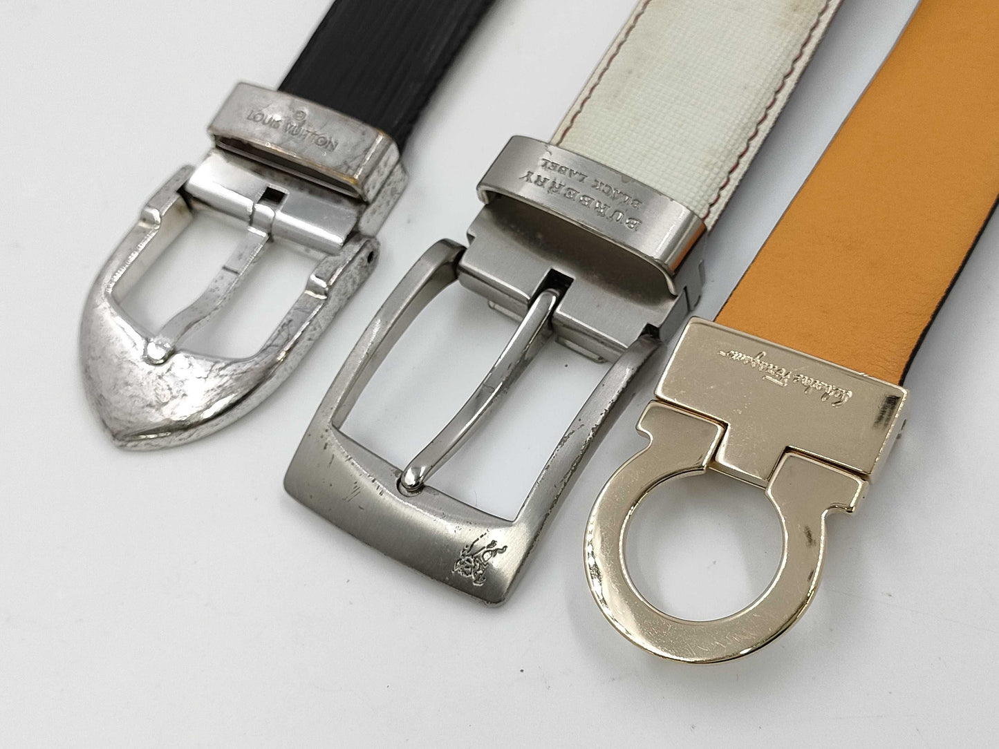 4 Salvatore Ferragamo belts: Gancini, Louis Vuitton, Burberry, and Coach.