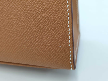 HERMES Kelly 25 handbag with gold exterior, Epsom finish, and silver hardware.