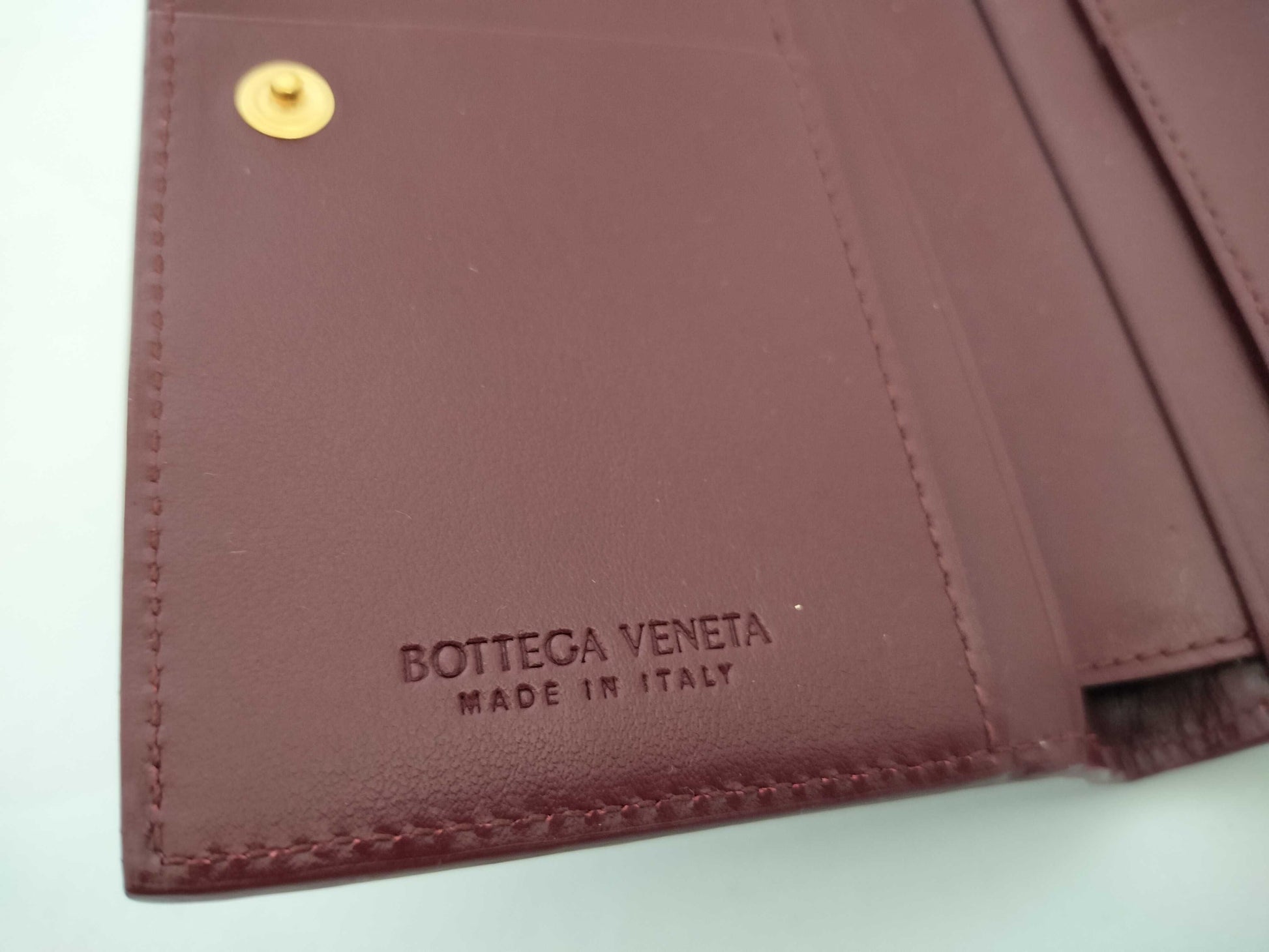 BOTTEGA VENETA 749940VCPP22247 Bi-fold Wallet, Barolo Bordeaux Leather, Gold, 2025 Current Model