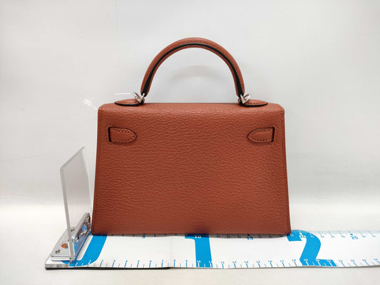HERMES Kelly Mini II Cuivre Shoulder Bag with P hardware, Chevre U stamp, and protective seal