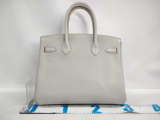 HERMES Birkin 30 handbag in ivory with silver hardware and a C stamp.