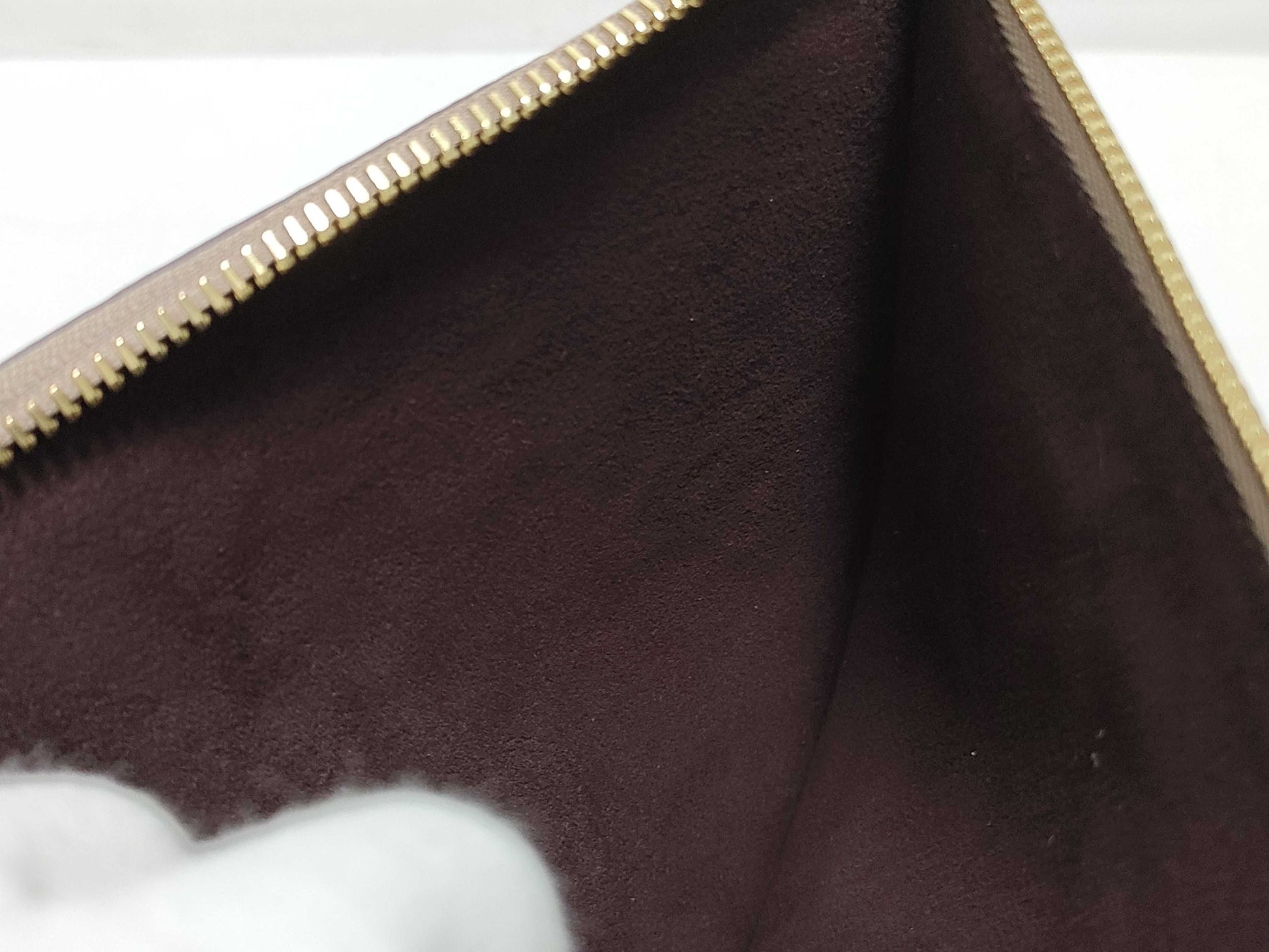LOUIS VUITTON RFID verification impossible. Serial number verification impossible. Monogram Empreinte Louis Vuitton Neverfull Pouch in Taupe with Gold Hardware.