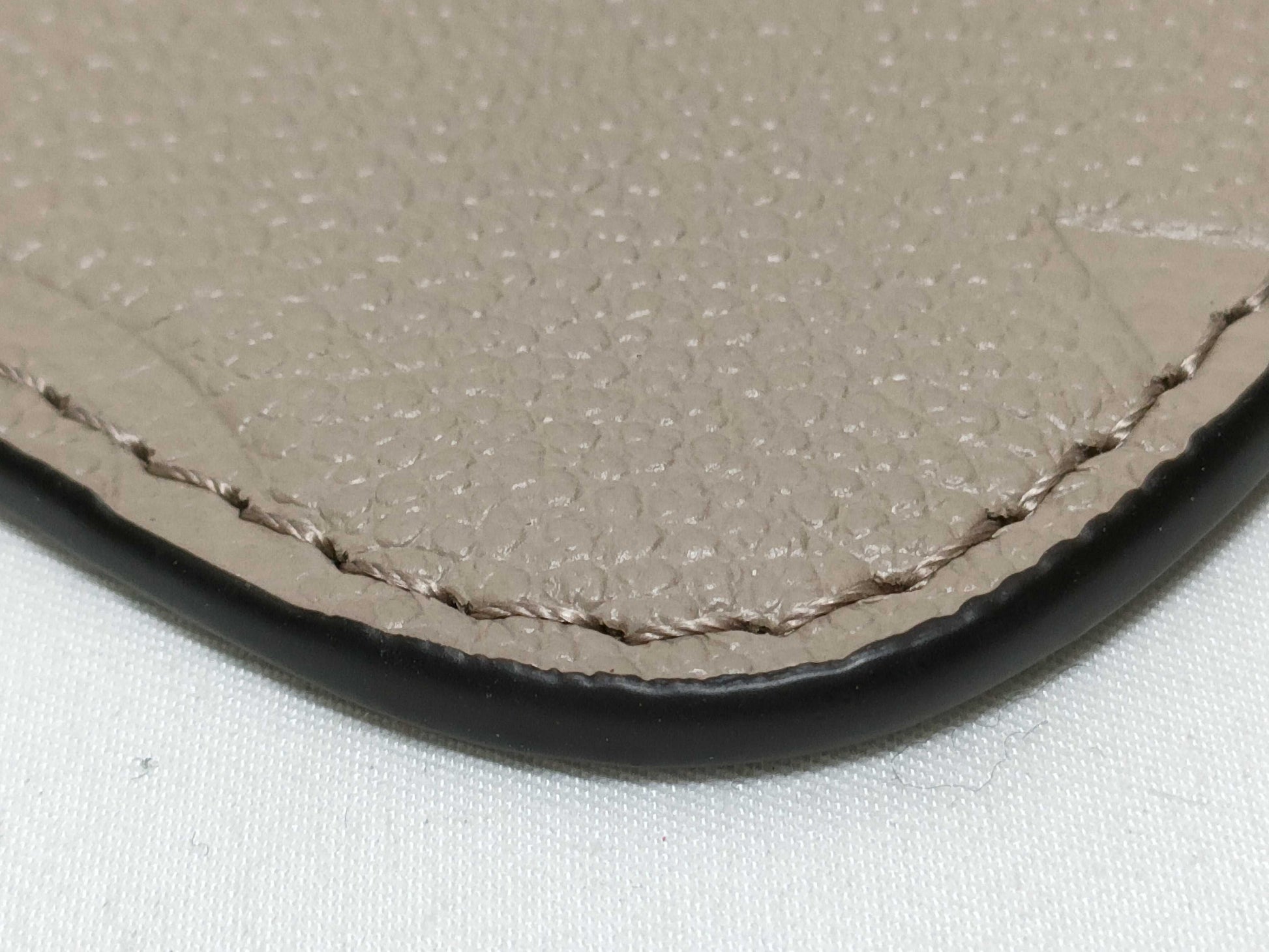 LOUIS VUITTON RFID verification impossible. Serial number verification impossible. Monogram Empreinte Louis Vuitton Neverfull Pouch in Taupe with Gold Hardware.
