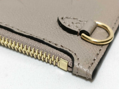 LOUIS VUITTON RFID verification impossible. Serial number verification impossible. Monogram Empreinte Louis Vuitton Neverfull Pouch in Taupe with Gold Hardware.