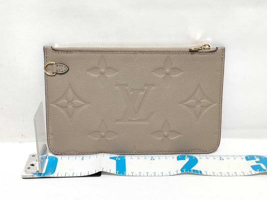 LOUIS VUITTON RFID verification impossible. Serial number verification impossible. Monogram Empreinte Louis Vuitton Neverfull Pouch in Taupe with Gold Hardware.