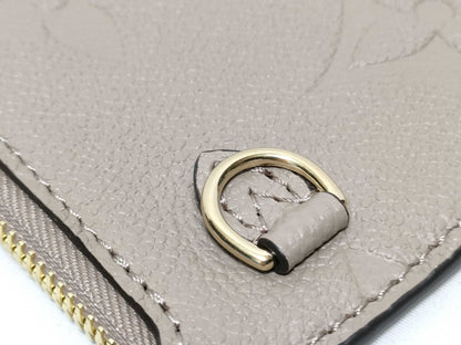 LOUIS VUITTON RFID verification impossible. Serial number verification impossible. Monogram Empreinte Louis Vuitton Neverfull Pouch in Taupe with Gold Hardware.