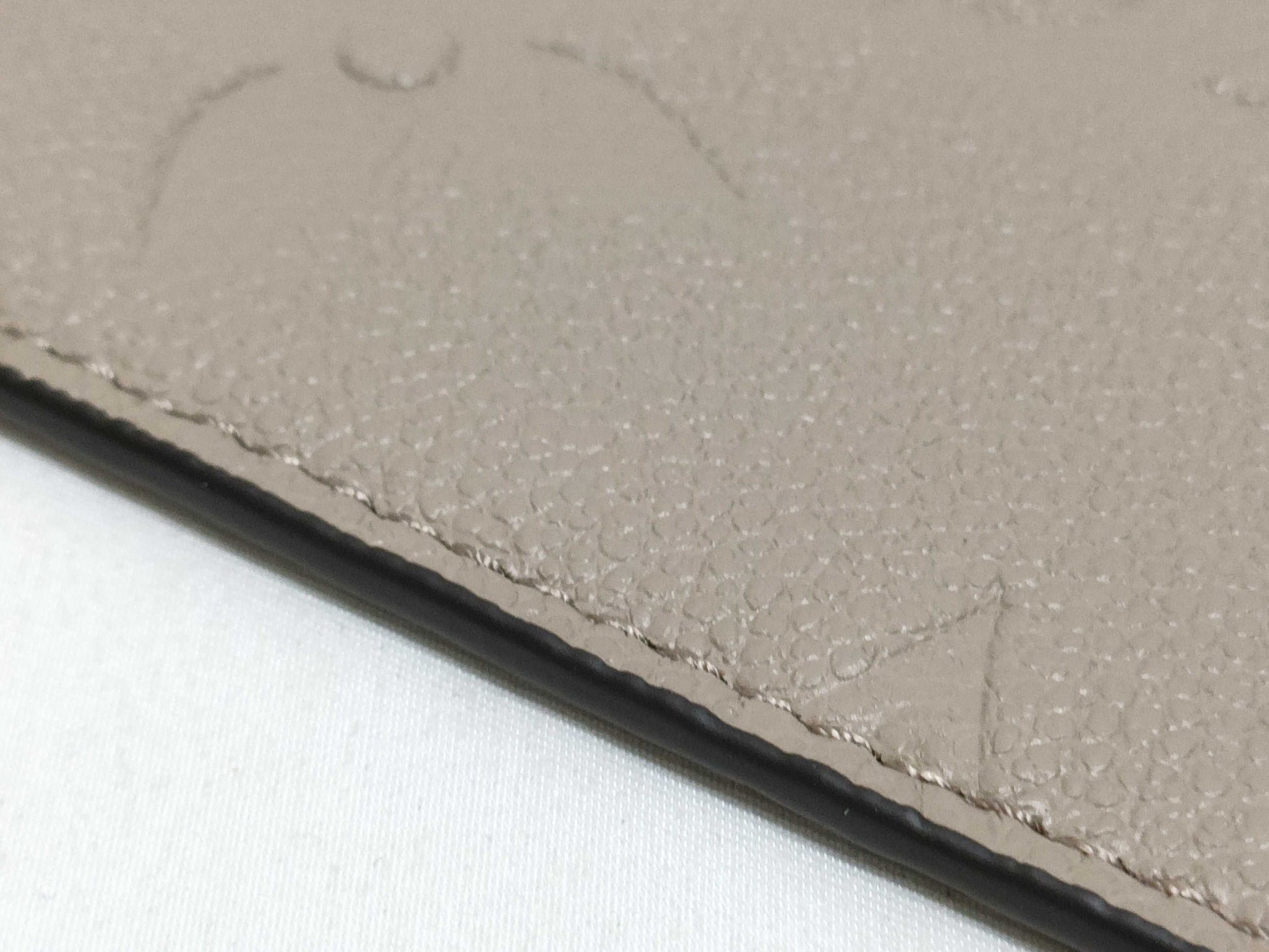 LOUIS VUITTON RFID verification impossible. Serial number verification impossible. Monogram Empreinte Louis Vuitton Neverfull Pouch in Taupe with Gold Hardware.