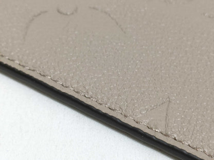 LOUIS VUITTON RFID verification impossible. Serial number verification impossible. Monogram Empreinte Louis Vuitton Neverfull Pouch in Taupe with Gold Hardware.