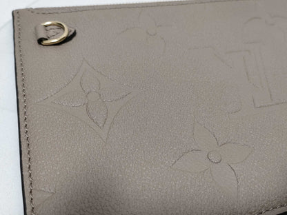 LOUIS VUITTON RFID verification impossible. Serial number verification impossible. Monogram Empreinte Louis Vuitton Neverfull Pouch in Taupe with Gold Hardware.