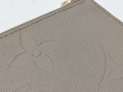 LOUIS VUITTON RFID verification impossible. Serial number verification impossible. Monogram Empreinte Louis Vuitton Neverfull Pouch in Taupe with Gold Hardware.