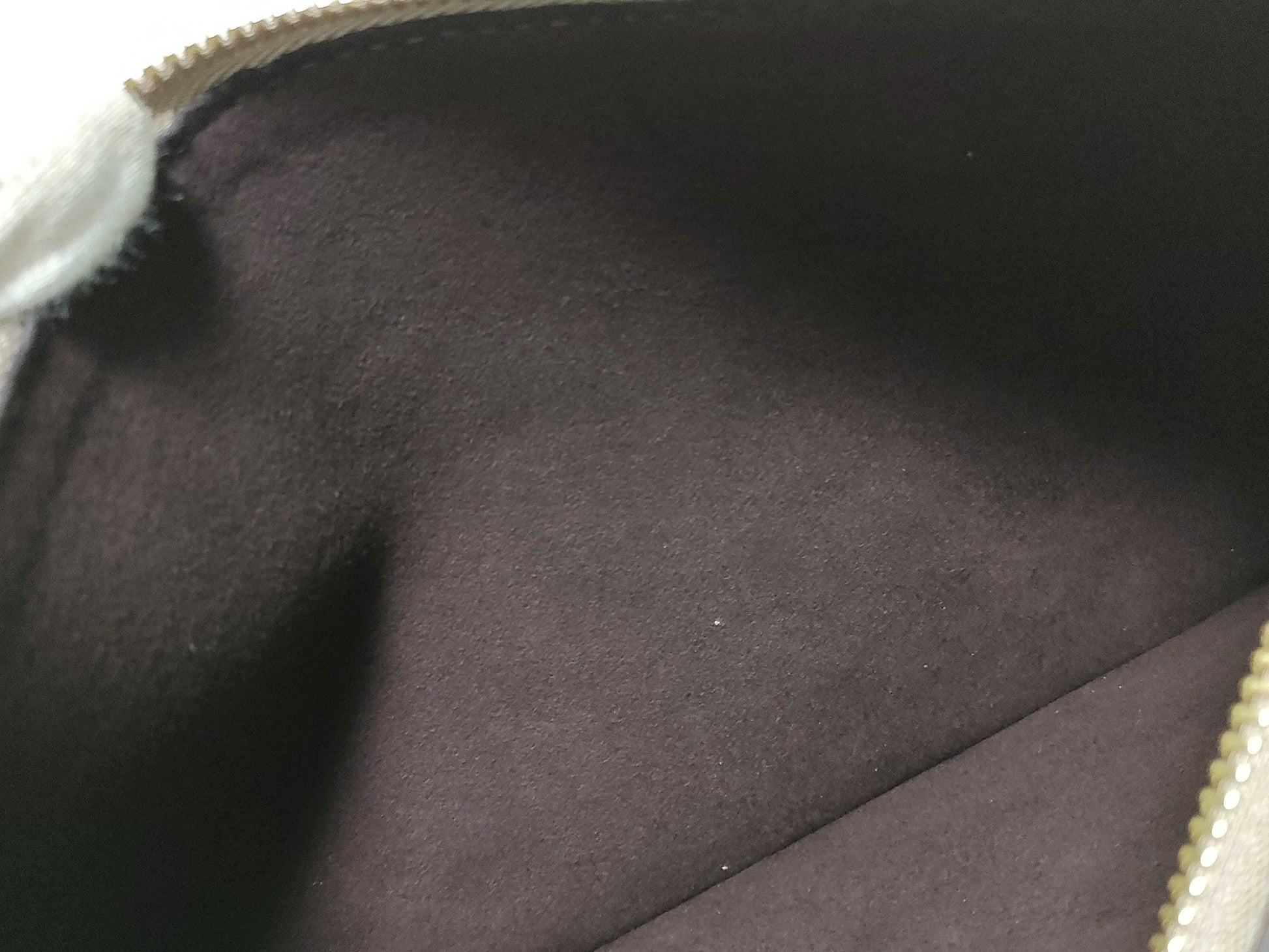 LOUIS VUITTON RFID verification impossible. Serial number verification impossible. Monogram Empreinte Louis Vuitton Neverfull Pouch in Taupe with Gold Hardware.