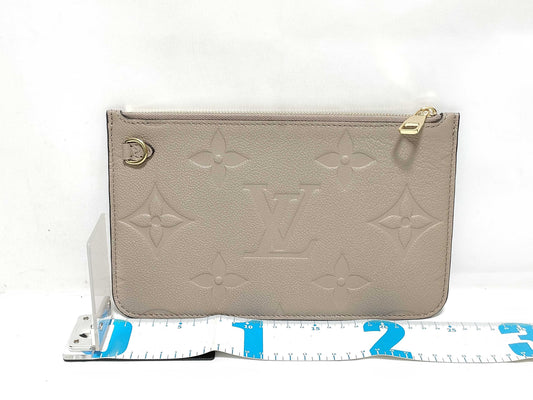 LOUIS VUITTON RFID verification impossible. Serial number verification impossible. Monogram Empreinte Louis Vuitton Neverfull Pouch in Taupe with Gold Hardware.