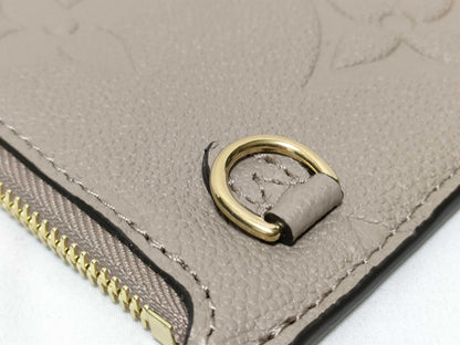 LOUIS VUITTON RFID verification impossible. Serial number verification impossible. Monogram Empreinte Louis Vuitton Neverfull Pouch in Taupe with Gold Hardware.