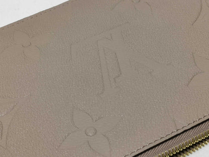 LOUIS VUITTON RFID verification impossible. Serial number verification impossible. Monogram Empreinte Louis Vuitton Neverfull Pouch in Taupe with Gold Hardware.