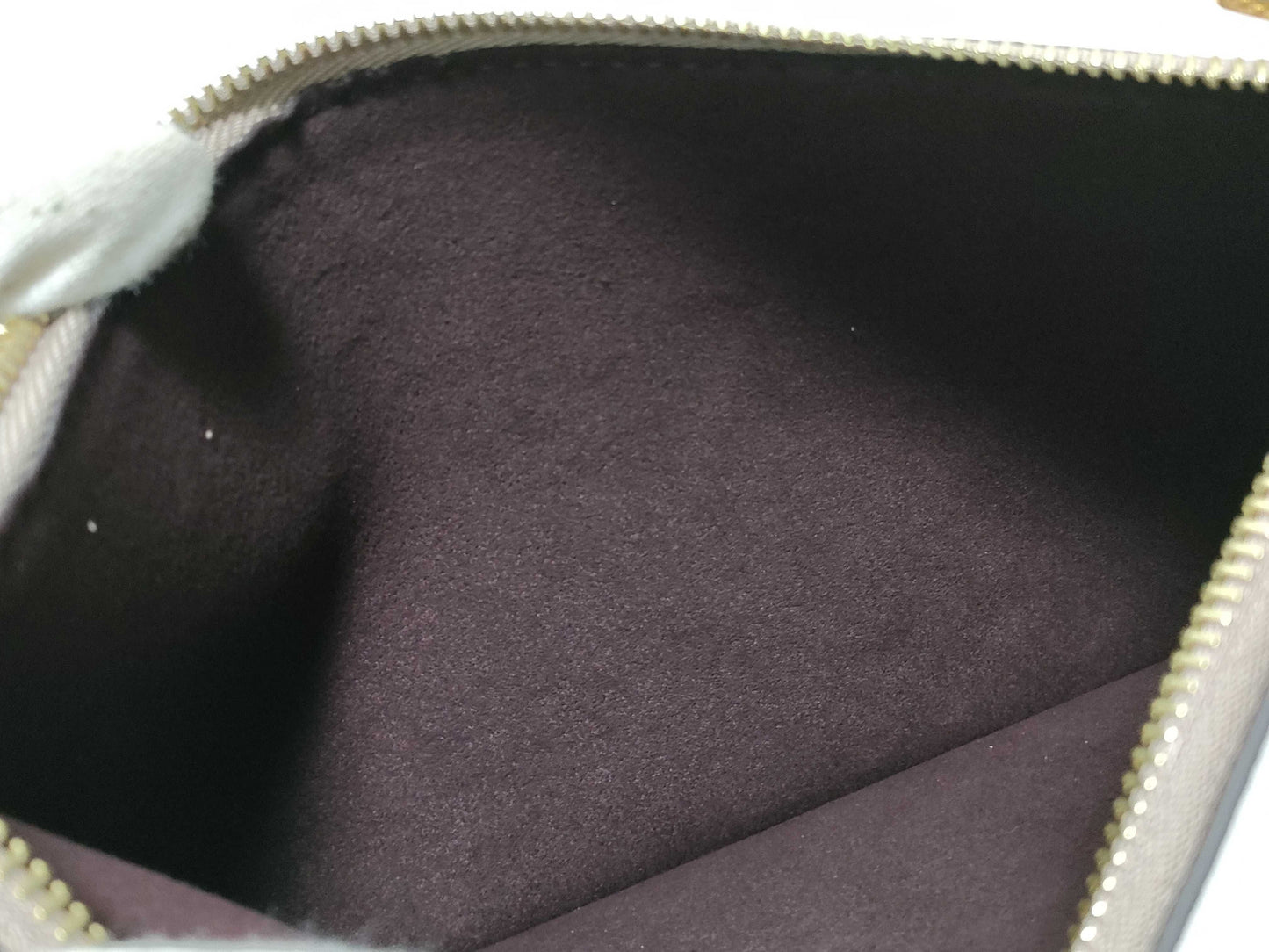 LOUIS VUITTON RFID verification impossible. Serial number verification impossible. Monogram Empreinte Louis Vuitton Neverfull Pouch in Taupe with Gold Hardware.