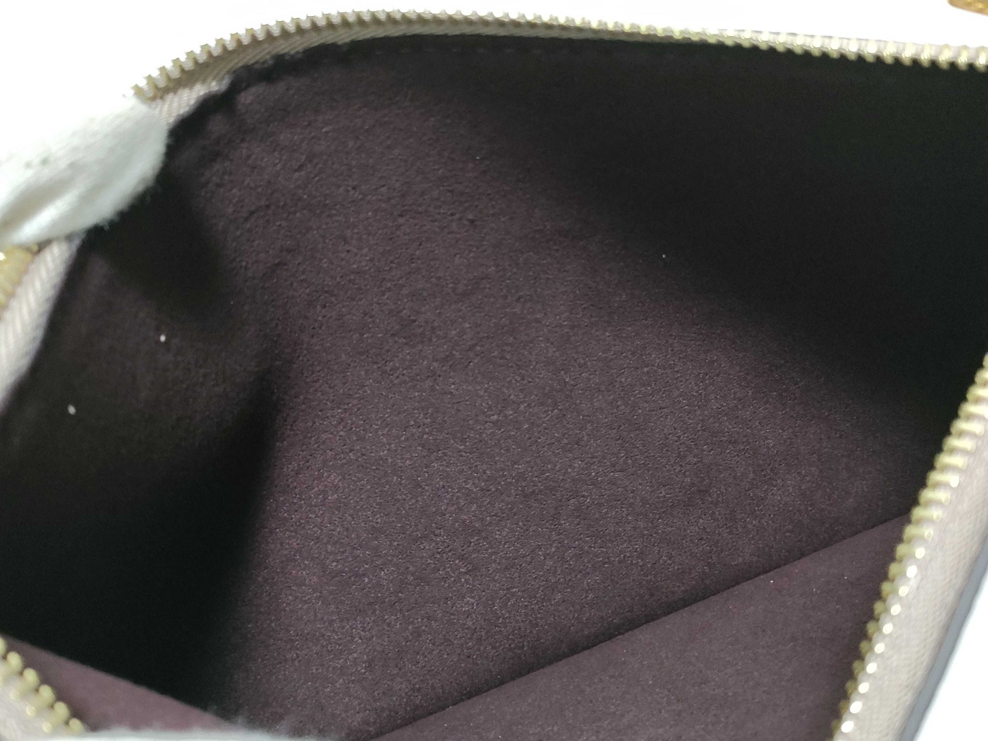 LOUIS VUITTON RFID verification impossible. Serial number verification impossible. Monogram Empreinte Louis Vuitton Neverfull Pouch in Taupe with Gold Hardware.
