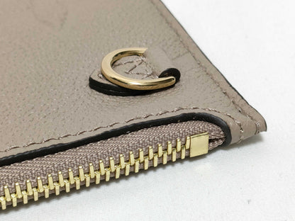 LOUIS VUITTON RFID verification impossible. Serial number verification impossible. Monogram Empreinte Louis Vuitton Neverfull Pouch in Taupe with Gold Hardware.