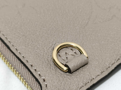 LOUIS VUITTON RFID verification impossible. Serial number verification impossible. Monogram Empreinte Louis Vuitton Neverfull Pouch in Taupe with Gold Hardware.