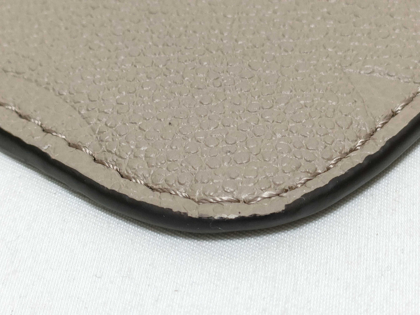 LOUIS VUITTON RFID verification impossible. Serial number verification impossible. Monogram Empreinte Louis Vuitton Neverfull Pouch in Taupe with Gold Hardware.