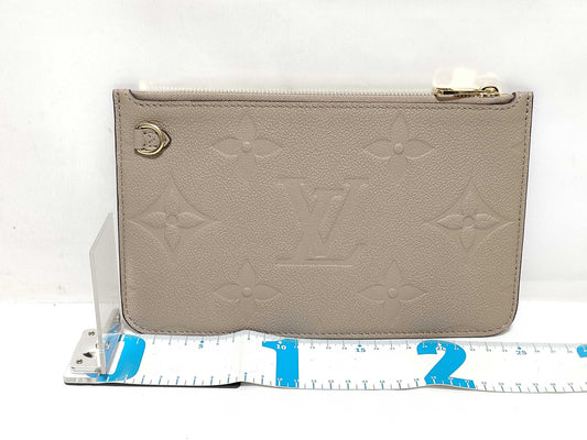 LOUIS VUITTON RFID verification impossible. Serial number verification impossible. Monogram Empreinte Louis Vuitton Neverfull Pouch in Taupe with Gold Hardware.