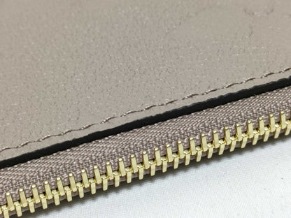 LOUIS VUITTON RFID verification impossible. Serial number verification impossible. Monogram Empreinte Louis Vuitton Neverfull Pouch in Taupe with Gold Hardware.